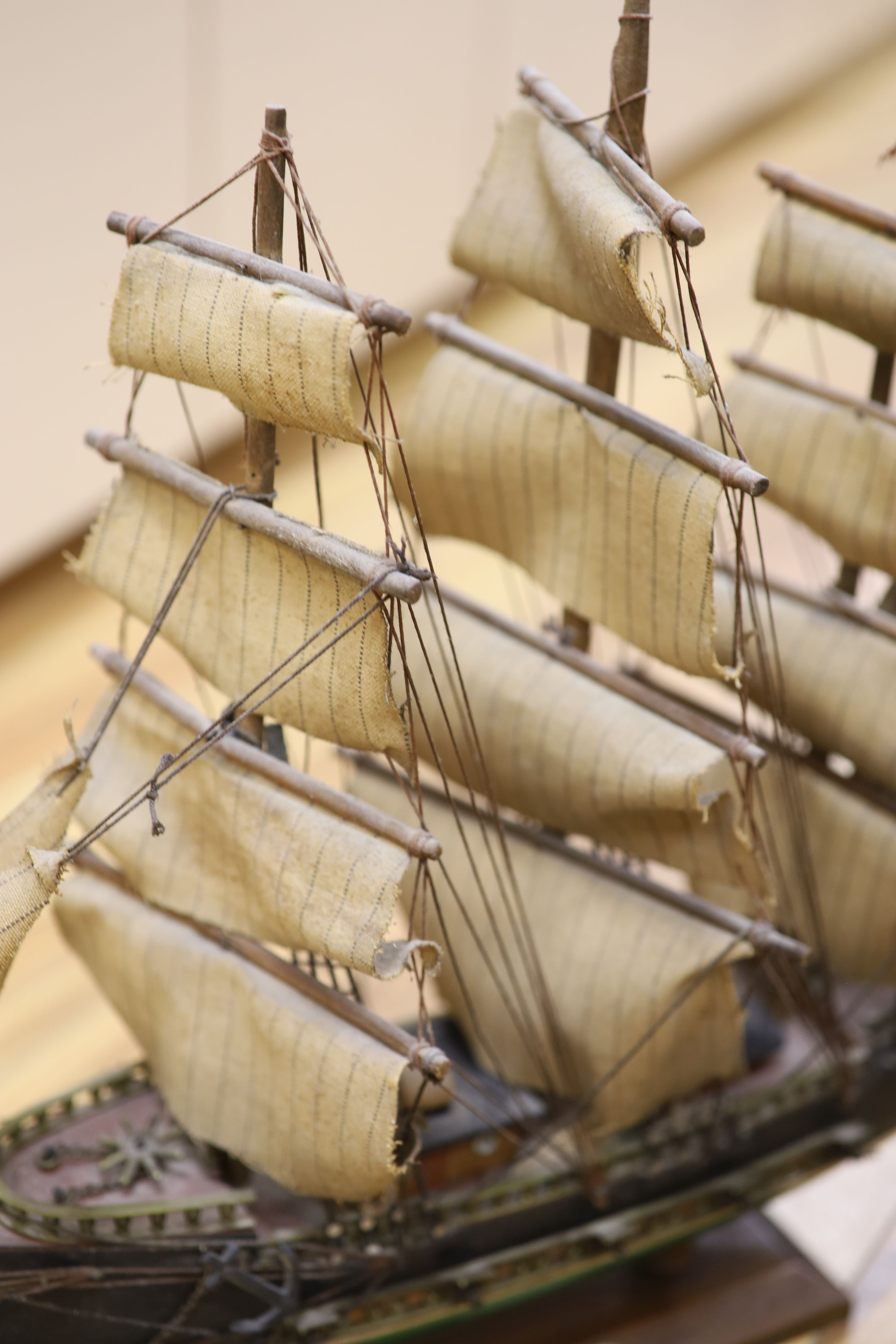 Three model ships: The Cutty Sark, The USS Constitution and Fragata, together with a carved wood Marlin